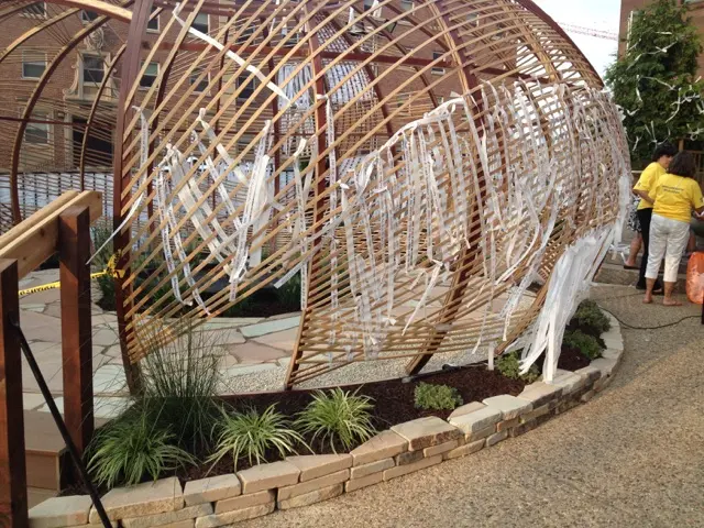 Stone edging, ornamental grass and prayer ribbons at the Knotted Grotto