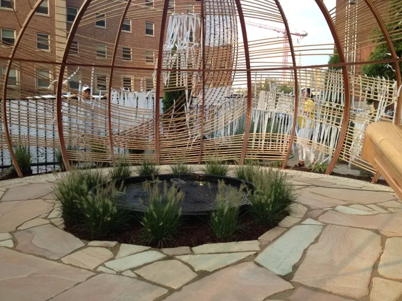 Planting and stonework inside the woven Knotted Grotto structure